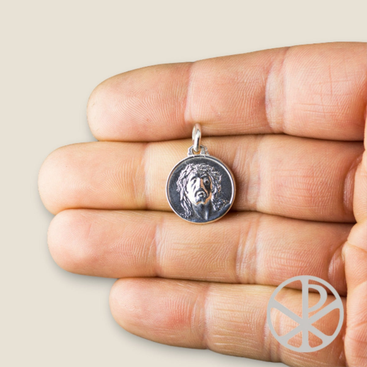 Medalla Ecce Homo en plata - sobre una mano