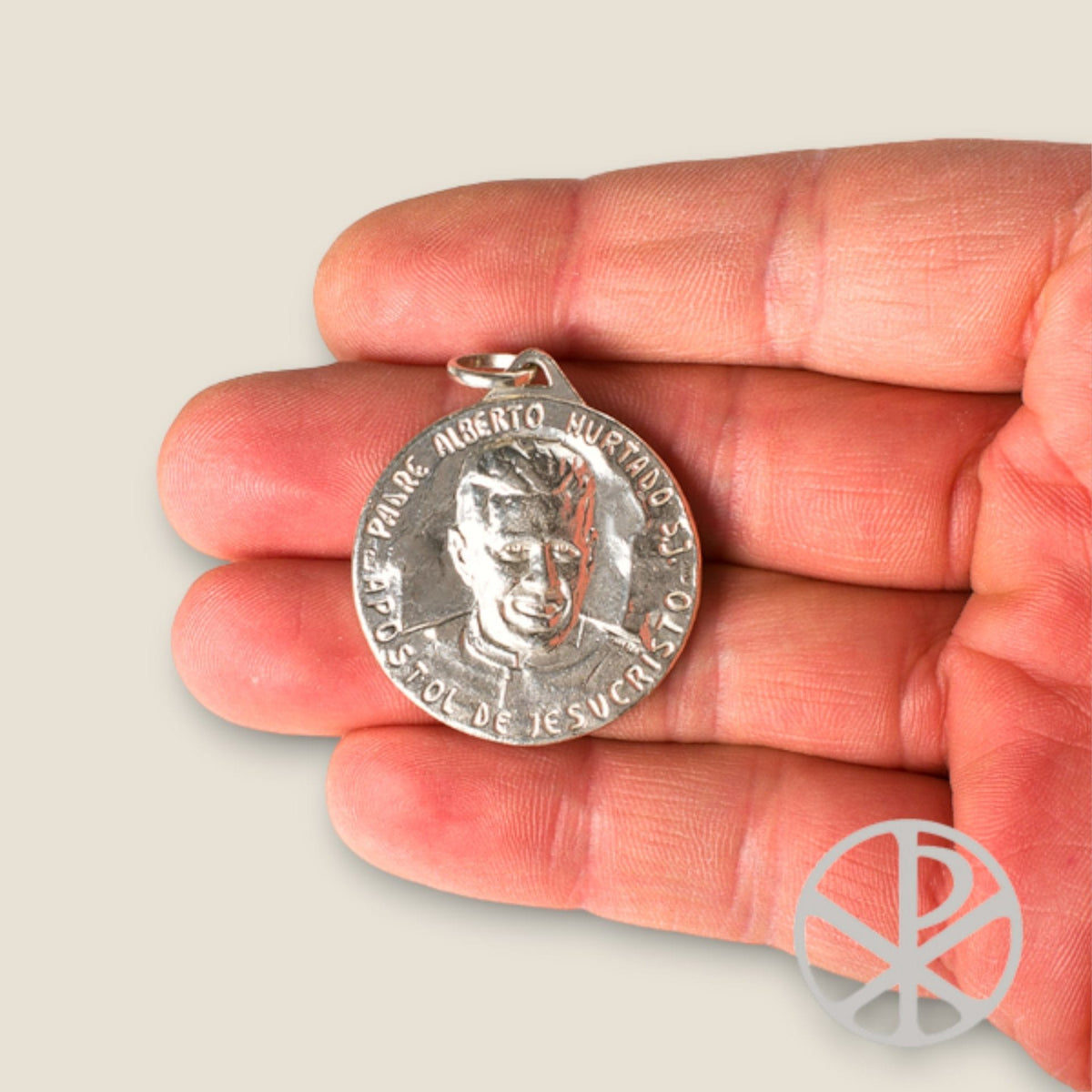 Medalla de San Alberto Hurtado en plata - sobre una mano