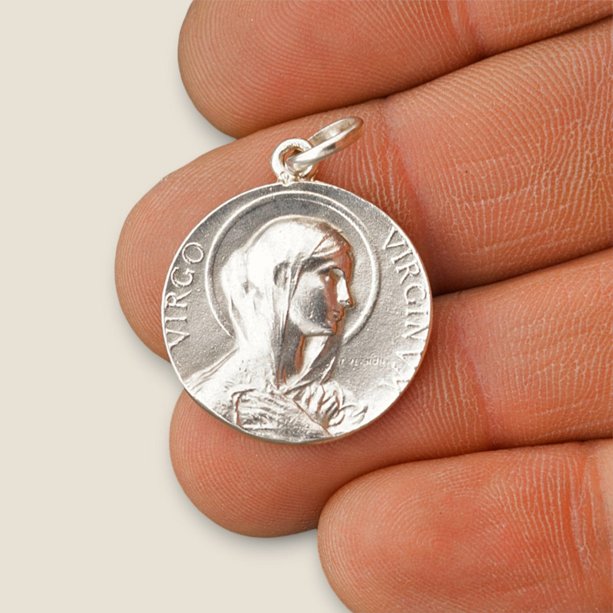 Medalla de la Virgen María en plata - sobre una mano
